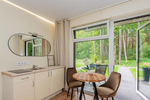 a kitchen and dining room with a table and chairs at Seaside apartments 2 in Palanga