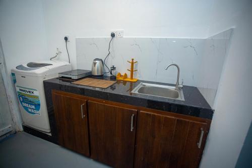 a small kitchen with a sink and a refrigerator at Villa Beach Zone in Talpe