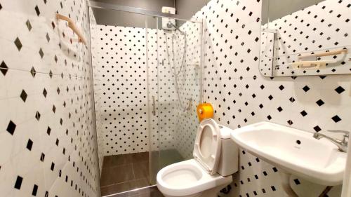 a bathroom with a toilet and a sink at Jurockotel in Pattaya Central