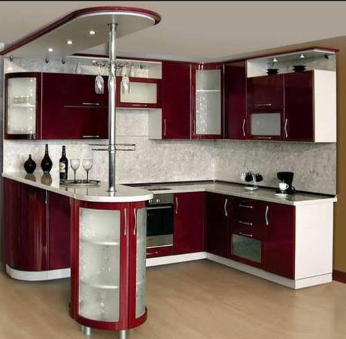 a kitchen with red cabinets and a counter in a room at المساكن 