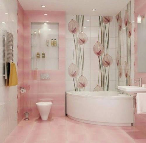 uma casa de banho cor-de-rosa com uma banheira e um WC. em المساكن 