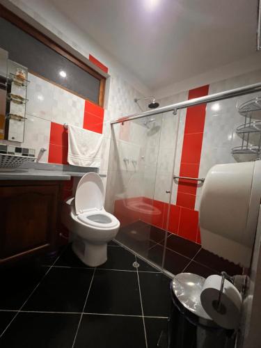 a bathroom with a toilet and a glass shower at Casa De Las Flores Hotel SPA in Villa de Leyva