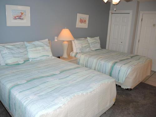 two beds sitting next to each other in a bedroom at Studio Home 1203L at Brunswick Plantation Resort and Golf Villas in the Heart of NC Seafood Country studio in Calabash