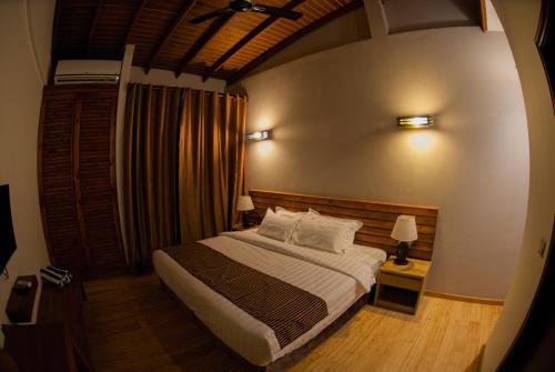 a bedroom with a bed in a room at Aveyla Manta Village in Dharavandhoo