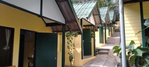 a row of houses with green and yellow walls at Island Lodge in Ko Chang