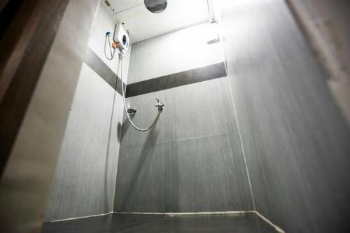 a shower with a hose on a wall at Apartment Ground floor in El Nido