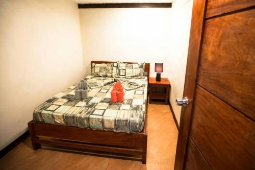 a small bedroom with a bed with an orange object on it at Apartment Ground floor in El Nido