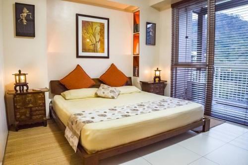 a bedroom with a large bed and a window at Family beach apartment with lagoon view at Pico de Loro in Nasugbu