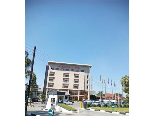 a building with a bus stop in front of it at Grand Palace Hotel Lusaka in Lusaka