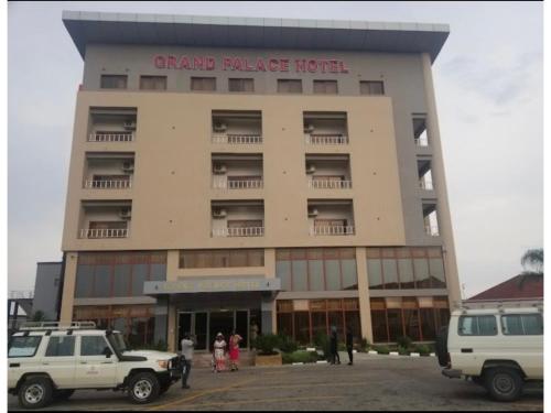 a grand palace hotel with cars parked in front of it at Grand Palace Hotel Lusaka in Lusaka