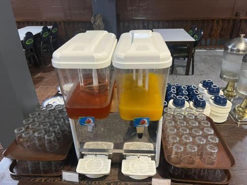 two plastic containers filled with different types of drinks at Malibest Premier in Pantai Cenang