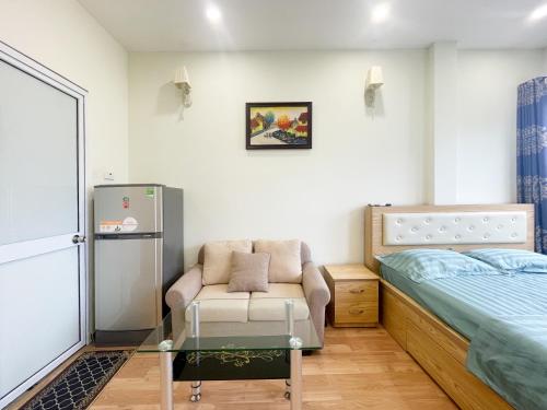 a small bedroom with a bed and a chair at Joy Homestay in Hanoi