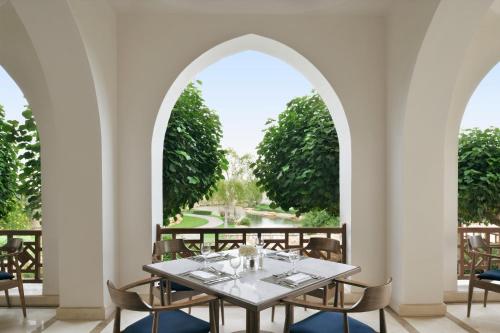 a dining room with arches and a table and chairs at InterContinental Durrat Al Riyadh Resort & Spa by IHG in Riyadh