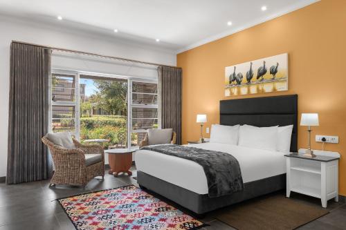 a hotel room with a bed and a large window at Park Hotel Mokopane in Mokopane