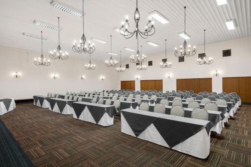 a large banquet hall with chairs and tables and chandeliers at Park Hotel Mokopane in Mokopane