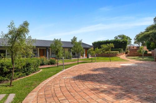a brick driveway in front of a house at Park Hotel Mokopane in Mokopane