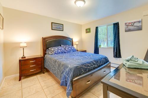 a bedroom with a bed and a desk and a window at Lovely Soldotna Home, Steps From Kenai River in Soldotna