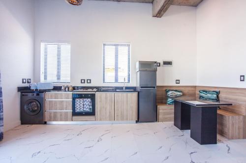 a kitchen with a stove and a counter in a room at Yzerfontein Villa Fantastica - No Loadshedding in Yzerfontein
