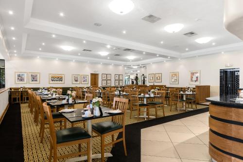 a dining room with wooden tables and chairs at Park Hotel Mokopane in Mokopane