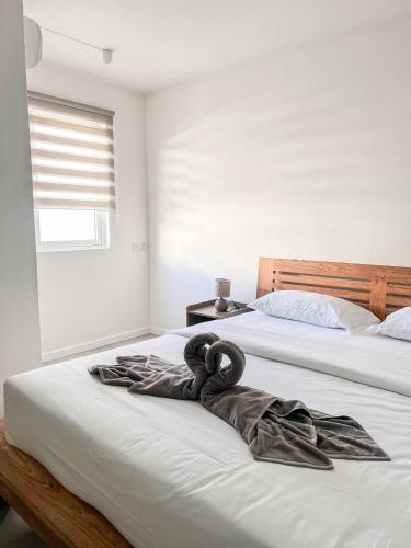 a robe laying on a bed in a bedroom at Bleu Des Zil in Grand Baie