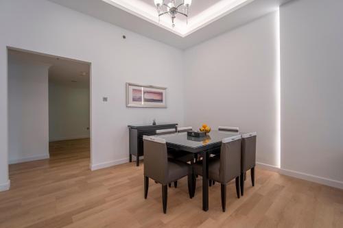 a dining room with a table and chairs at Rose Garden Hotel Apartments - Al Barsha, Near Metro Station in Dubai