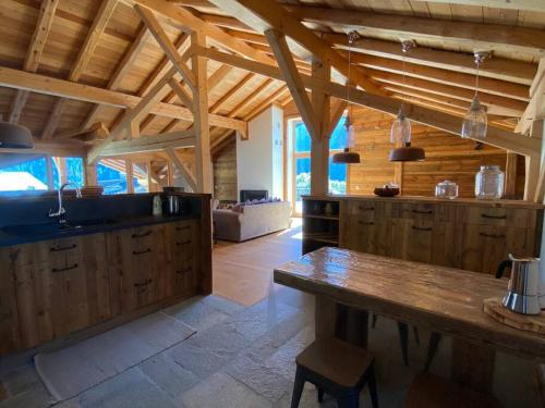 a large kitchen with a table in a room at Chalet de charme 190m2, La Lauzière, ski à pieds in Peisey-Nancroix