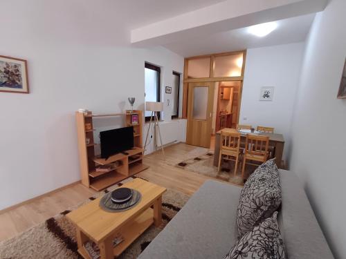 a living room with a couch and a table at Apartmani Damir in Sarajevo
