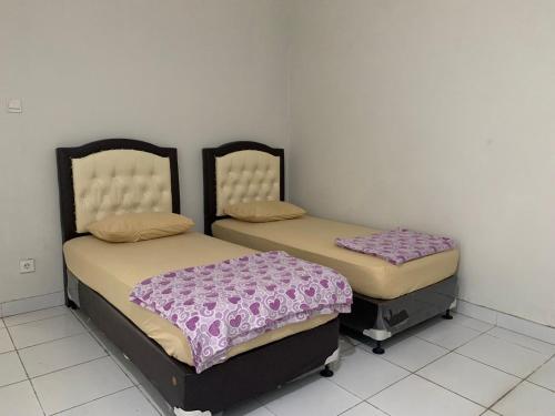Postel nebo postele na pokoji v ubytování Mandi Angin "Syariah" Homestay