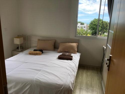 a large bed in a room with a window at Le Grand Bleu in Koh Samui