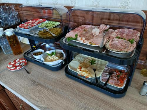 a buffet with several trays of food on a table at uDany Noclegi obok Gondoli in Szczyrk