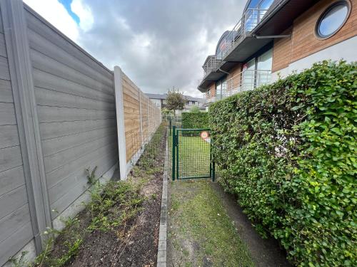 a gate in a fence next to a building at Prinses Elisabeth in Koksijde