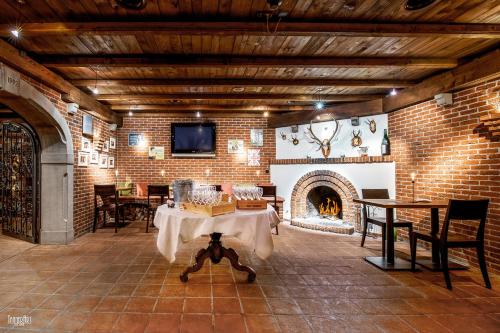 a living room with a table and a fireplace at Hirschen Erlinsbach Swiss Quality in Erlinsbach