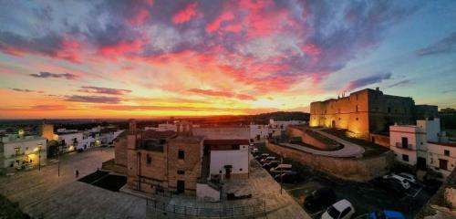 an aerial view of a city with a sunset at La loggetta 63 in Palagianello