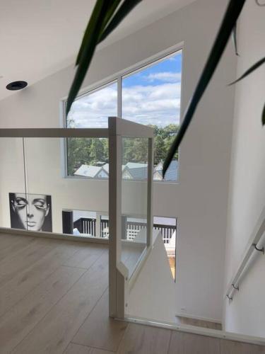 a living room with a staircase and a large window at Top Floor Apartment Årossanden 5 A in Kristiansand