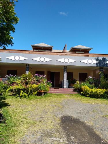 a building with a lot of flowers in front of it at Chez Claudia in Salazie
