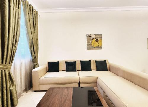 a living room with a couch and a window at RH - Spacious & bright 01BR, Near mall of Emirates in Dubai