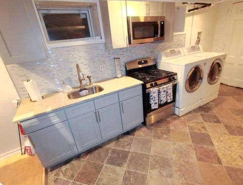 a kitchen with a sink and a washing machine at Westchester W/I minutes to NYC in Mount Vernon