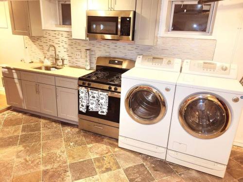 a kitchen with a washer and dryer and a stove at Westchester W/I minutes to NYC in Mount Vernon