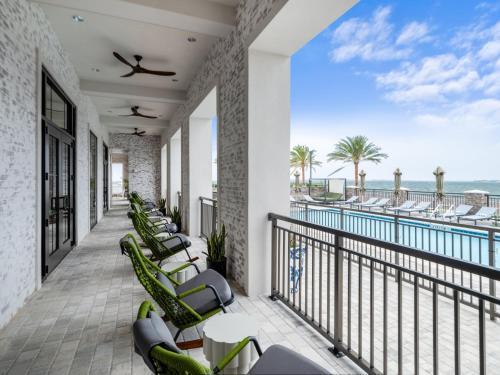 a resort balcony with chairs and a pool at Hotel Indigo - Panama City Marina, an IHG Hotel in Panama City