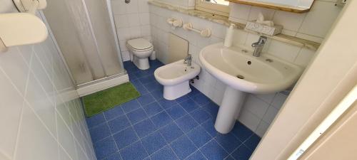 a bathroom with a sink and a toilet and a sink at I Sollazzi in Palermo