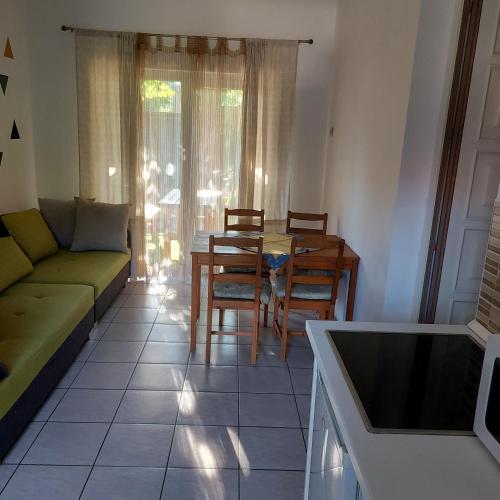 a living room with a couch and a table and chairs at Petra Vendégház in Szekszárd