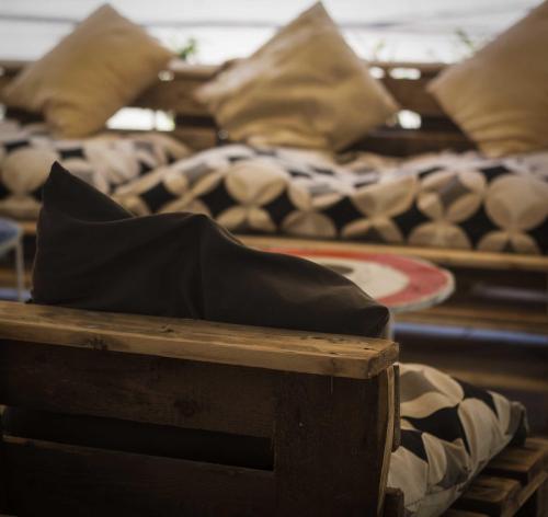 a row of couches with pillows on them at Hotel Nizza Creative Hotel in Rimini