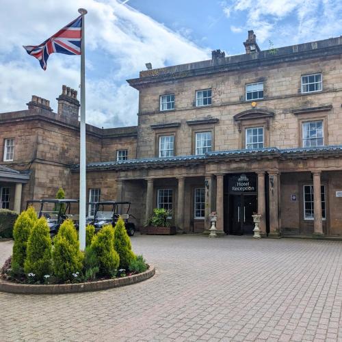 a flag on a pole in front of a building at Shaw Hill Hotel Golf And Country Club in Chorley