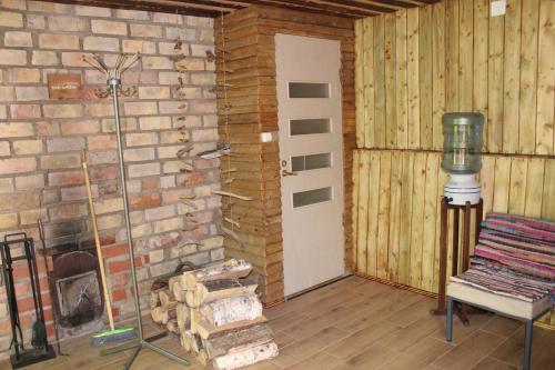 a room with a fireplace and a brick wall at PIE OPĪŠA in Cēsis