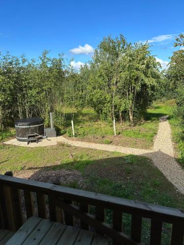 a view of a park from a deck at Cherry Tree Safari Lodge in Talaton