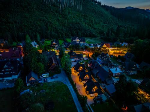 an aerial view of a small village at night at Osada Zbójnicka Turnia in Kościelisko