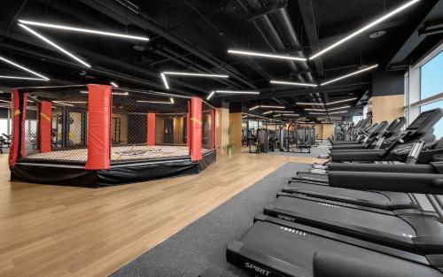 a gym with a row of treadmills and machines at TAI Urban Resort in Kaohsiung
