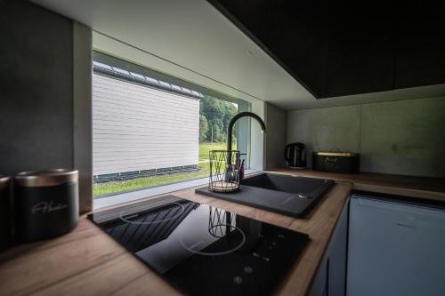 a kitchen with a sink and a large window at Łąckie Zacisze in Łącko