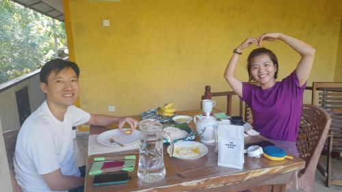 a man and a woman sitting at a table at Wild View Stay in Habarana