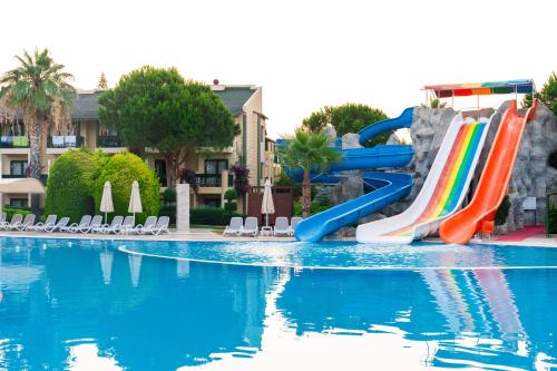 a pool with a water slide in a resort at Oz Hotels Incekum Beach in Alanya